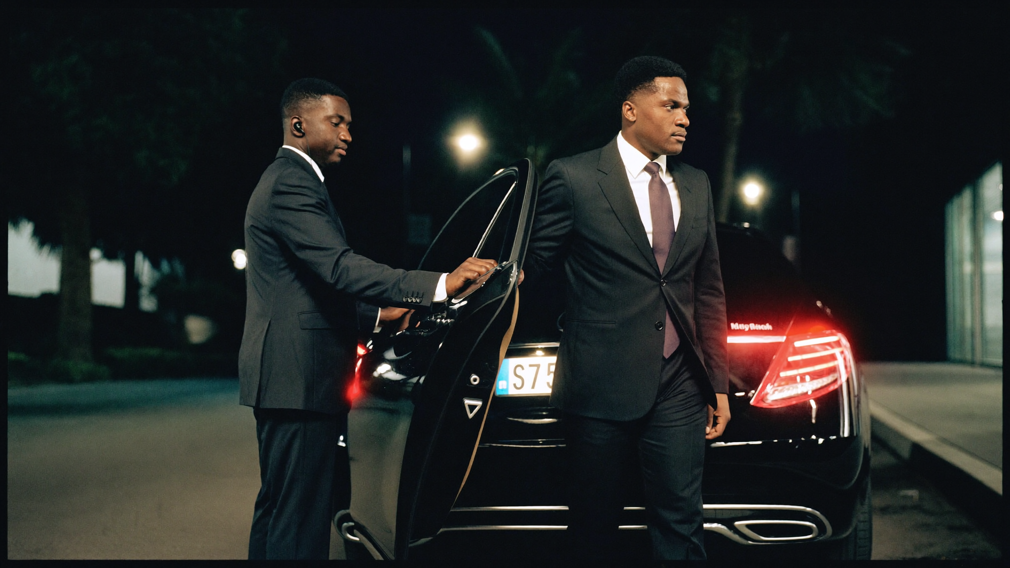 A principal met at the car by a protocol officer, Accra, at night