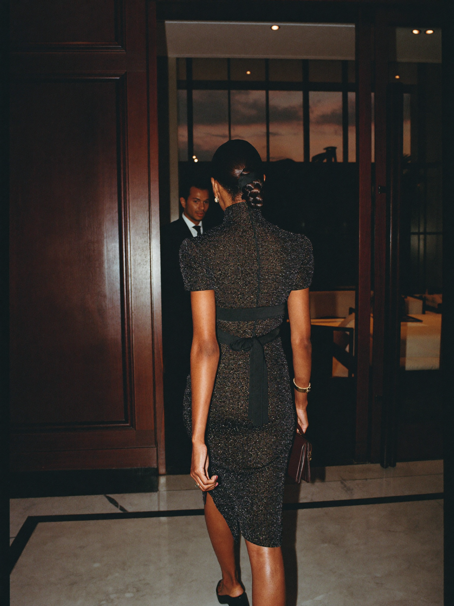 A guest crossing the lobby of a five-star Accra hotel at dusk